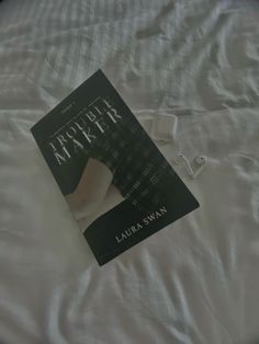 a book sitting on top of a white bed