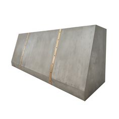 a large concrete block with two wooden strips on the side and one piece missing from it