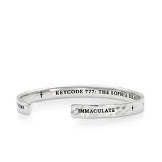 a silver cuff bracelet with the words,'key code 777 the sophia order