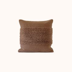 a brown pillow on a white background