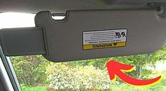 an arrow pointing to the left side of a car window with a warning sticker on it