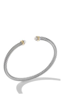 a silver and gold bracelet with two tone beads on the end, in front of a white background