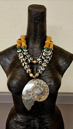 Earth Tone Ammonite Zebu Batik Bone & Wood Exotic Chest Piece, Unisex – KatKoutureJewelry Large Beads Necklace, Luxury Large Beads Ceremonial Jewelry, Bracelets 2022, Unique Handmade Bone-colored Necklace, African Shell Necklace, Rocker Chic Accessories, African Statement Necklace, Queens Jewels, Exotic Jewelry