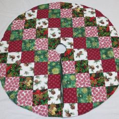 a red and green patchwork christmas tree skirt