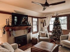 a living room filled with furniture and a christmas tree