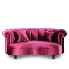 a pink couch with some pillows on it