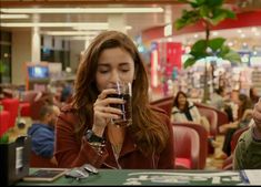 two people sitting at a table drinking wine