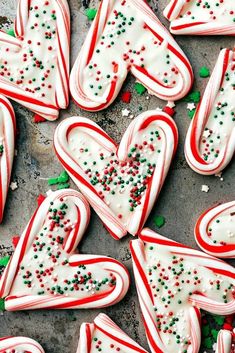 some very pretty decorated cookies with sprinkles and candy canens on them