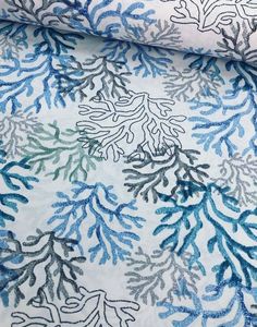 blue and green coral print on white fabric