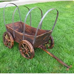 an old wooden wagon sitting in the grass