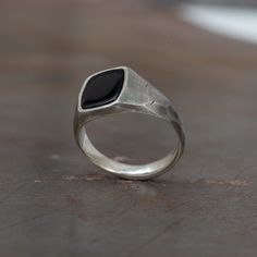 Discover sophistication with our Oxidized Silver Black Onyx Faceted Signet Ring, a distinguished choice for men seeking a timeless accessory. This black gem, with its onyx allure, makes a striking statement, ideal for both daily wear and special occasions. A thoughtful anniversary gift, this meticulously crafted ring showcases enduring style. Invest in sterling silver elegance and elevate your look with this exquisite piece. Oxidized and faceted fracture outside and polished inside Available in Onix Ring Man, Signet Rings Men, Sterling Silver Signet Ring With Black Enamel As Gift, Modern Onyx Signet Ring For Gift, Modern Onyx Signet Ring Gift, Modern Onyx Rings For Anniversary, Modern Onyx Ring For Anniversary, Modern Black Enamel Signet Ring For Anniversary, Polished Onyx Jewelry For Wedding