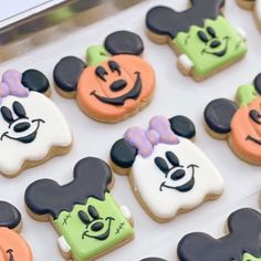 some decorated cookies in the shape of mickey mouses