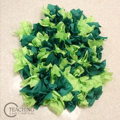 a pile of green tissue paper sitting on top of a table