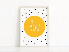 an orange and black polka dot print with the words be strong