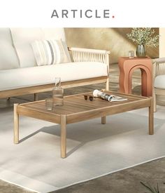 a coffee table sitting on top of a white rug