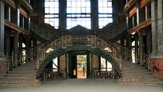 an ornate staircase in the middle of a large building