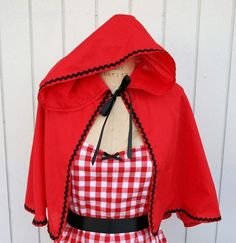 a red and white checkered dress with black trimmings on the neckline