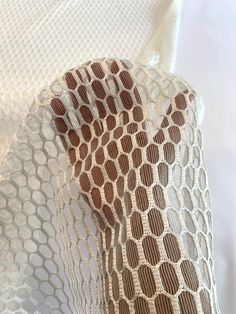 a close up of a piece of cloth on a white surface with circles and lines