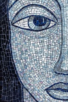 a mosaic face with blue eyes on it