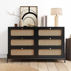 a black dresser with wicker drawers and a lamp on the sideboard next to it