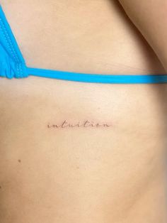 a woman's stomach with the word evolution tattooed on her lower side ribcage