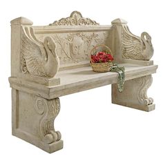 a white bench with a basket of flowers on it's back and an ornate carving