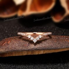 a diamond ring on top of a piece of wood