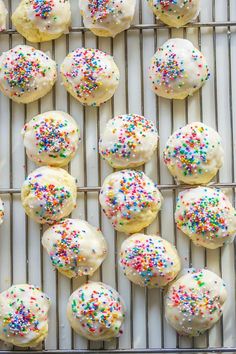 white frosted cookies with sprinkles on a cooling rack and text overlay that reads italian wedding cookies