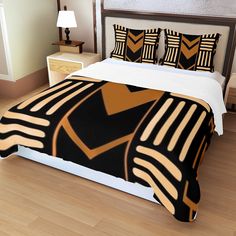 a bed with black, gold and white designs on it