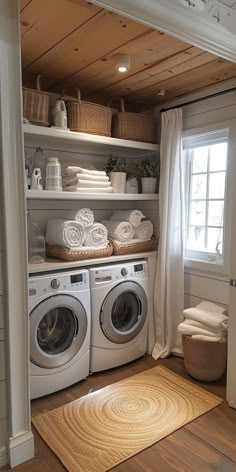 a washer and dryer in a small room with open shelving above them