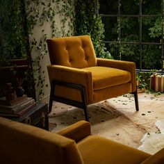 an orange chair sitting in front of a window