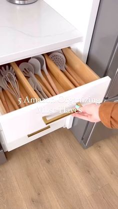 an open drawer with utensils in it