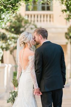 the bride and groom are standing together outside