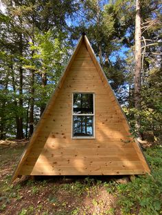 a - frame cabin in the woods with windows