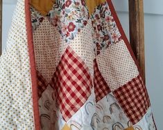 a quilt hanging on the back of a wooden chair