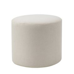 a white round ottoman sitting on top of a floor