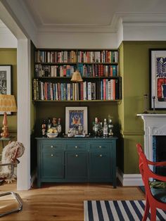 a living room filled with furniture and bookshelves covered in lots of bookcases