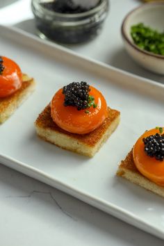 small appetizers are displayed on a white plate