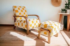 a chair and ottoman in the corner of a room with sun shining on the floor