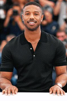 a man in black shirt standing next to camera