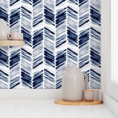 the wallpaper in this kitchen is made up of blue and white herringbones