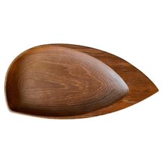 two wooden serving trays one is shaped like an oval and the other has curved sides