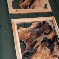 two wooden frames that have been made to look like wood pieces with black paint on them