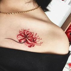 a woman's chest with a flower tattoo on it