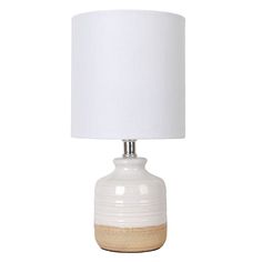 a white ceramic table lamp with a beige base and a white shade on the top