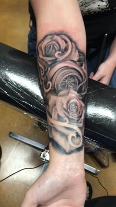 a person with a rose tattoo on their arm