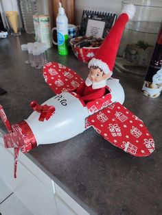 an elf is sitting on top of a toy airplane