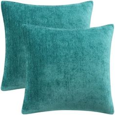 two teal pillows on white background