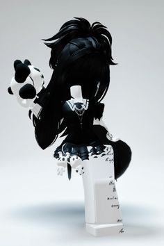 a black and white panda doll sitting on top of a table