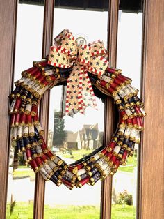 a patriotic wreath is hanging on the front door